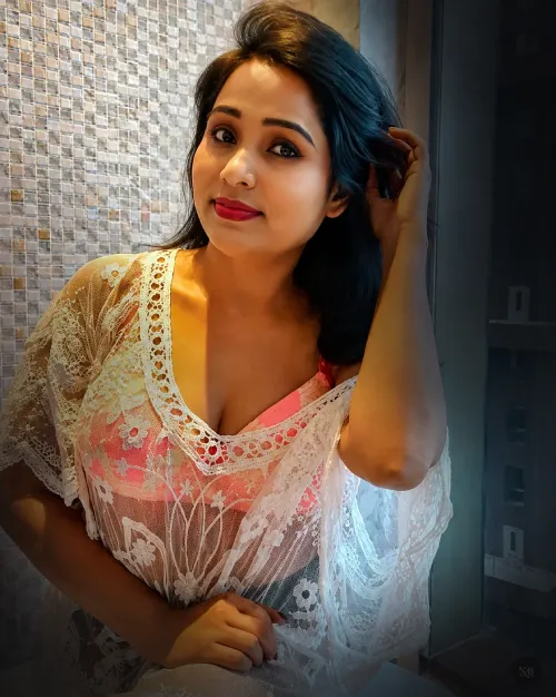 Massage Spa in Ajman Exotic Indian massage center ajman lady posing for the photo in white blouse and red saree